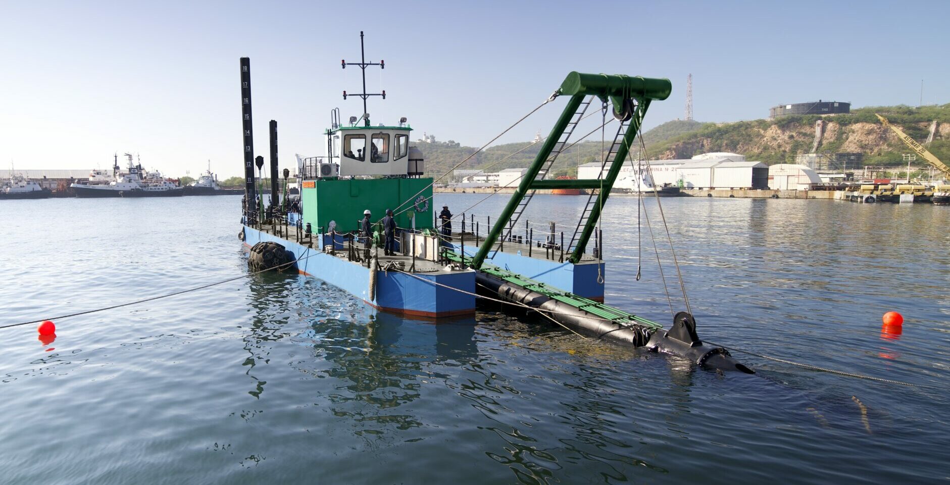 Dredging barge with discharge pipeline working a navigation channel, the plant matched to the sediment and disposal method