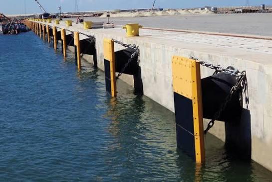 Vessel berthing alongside a fendered quay wall in a UK port