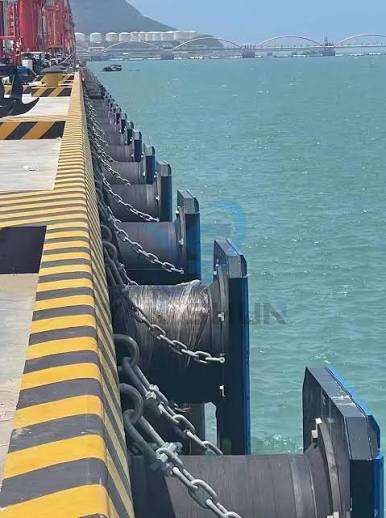Heavy mooring lines secured to a cast bollard on a UK quayside